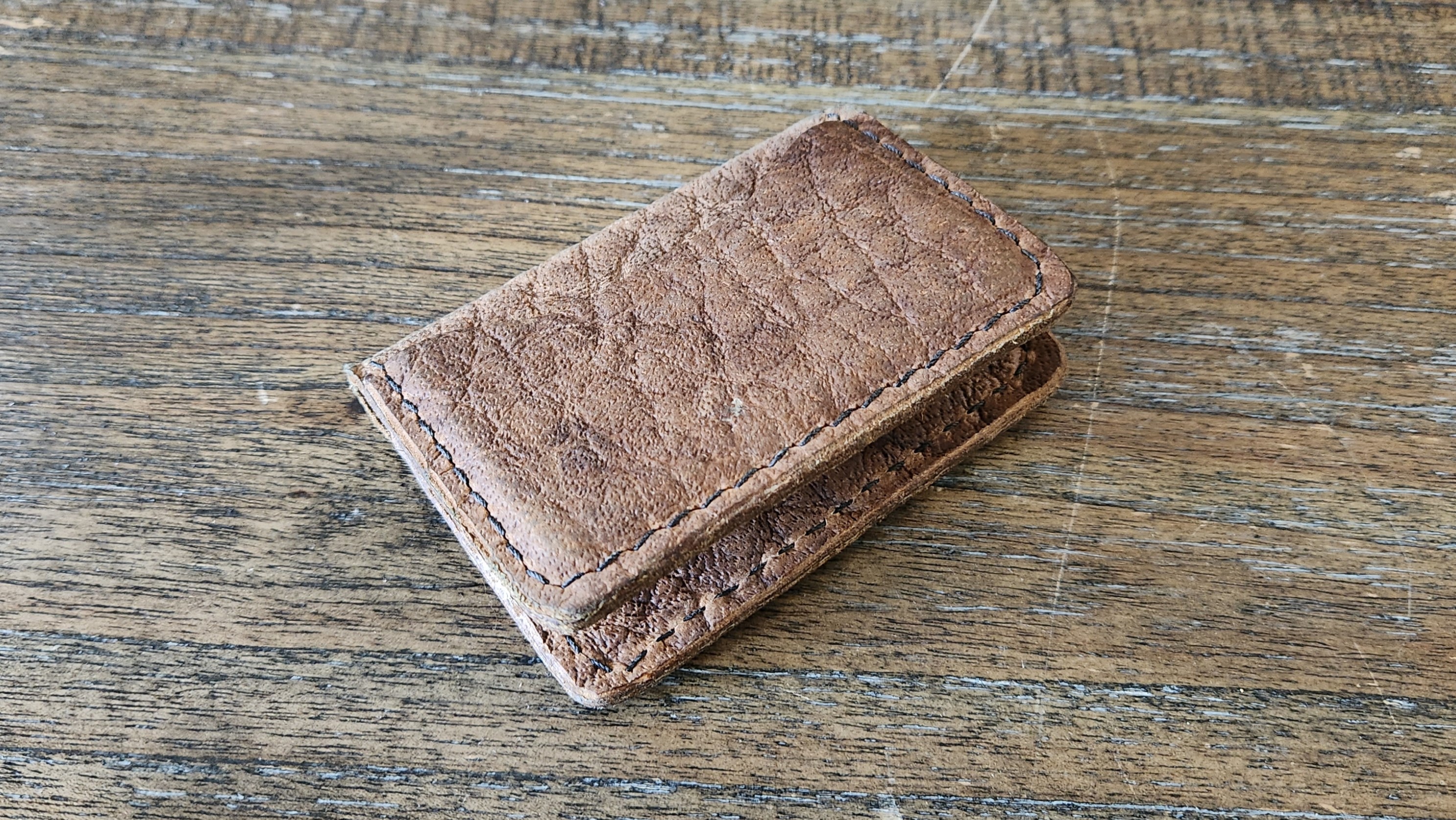 Simple bi-fold card wallet made of light brown buffalo leather
